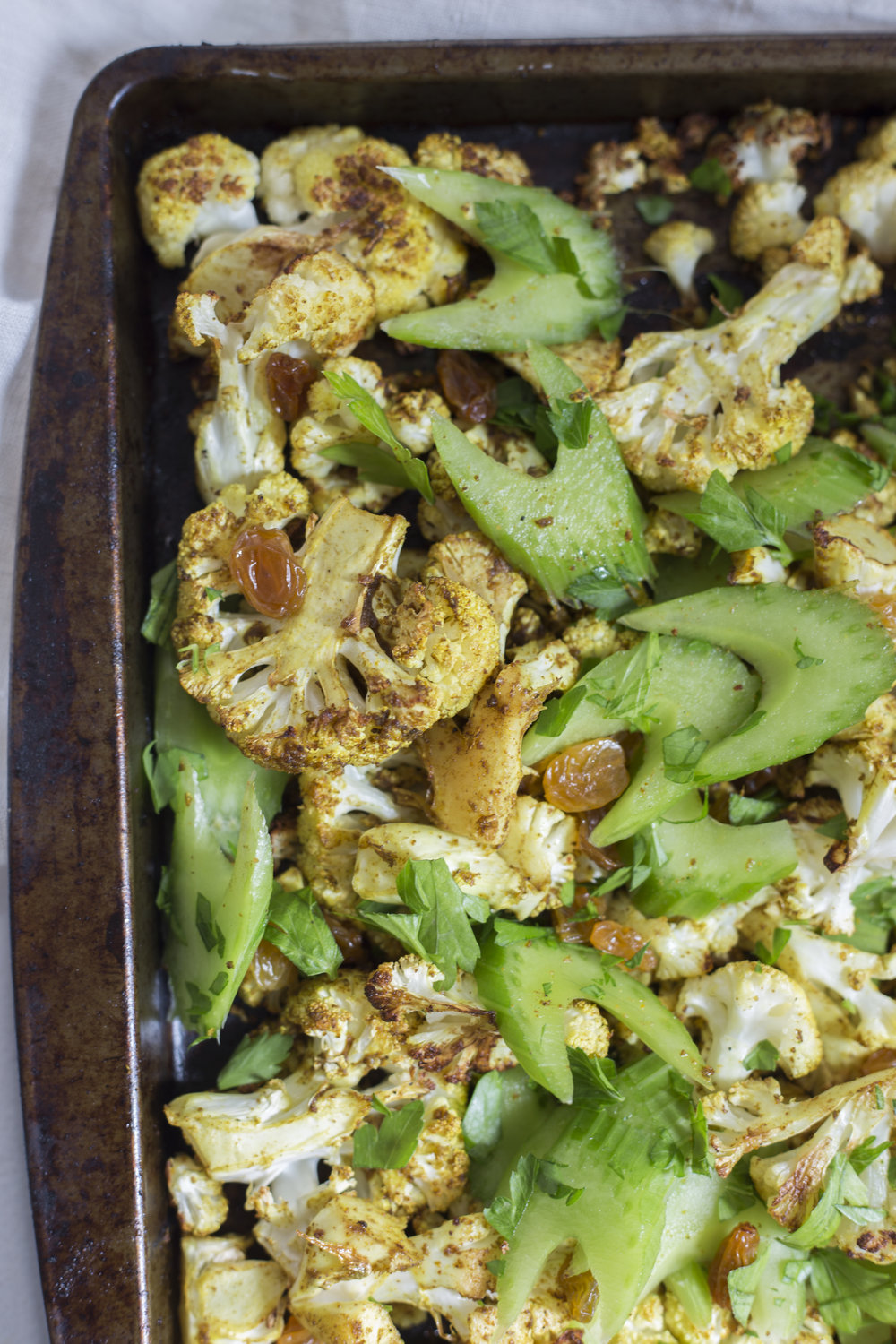 Curried Cauliflower with Golden Raisins and Celery Leaves