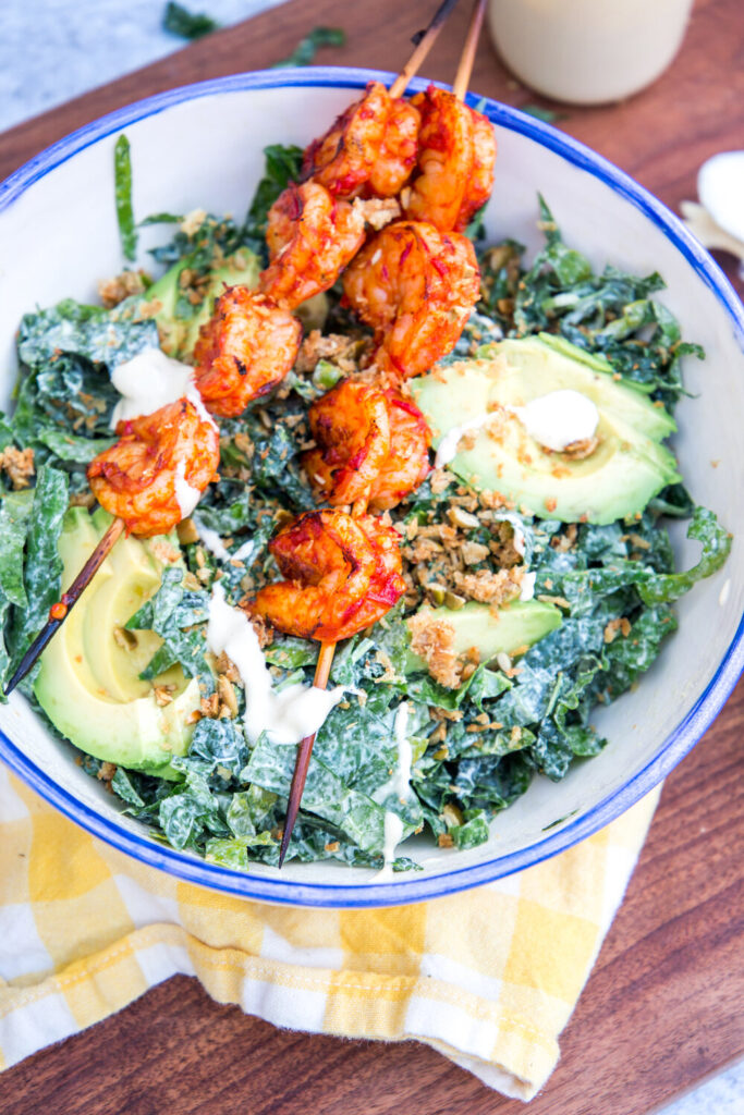 Kale Caesar Salad with Harissa Grilled Shrimp and Nutty Parmesan Crouton Crumbles